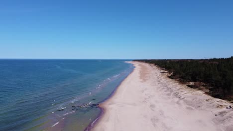 Wild-coastline-of-Baltic-sea-with-blue-sky,-aerial-drone-view