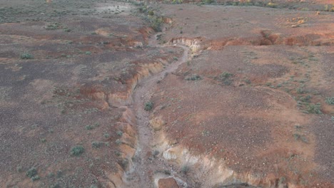 Aerial-ascending-dry-creek-arid-location-of-Wilpena-Pound,-Australia