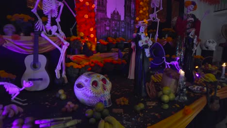 Altar-of-the-dead-created-for-the-celebration-of-the-day-of-the-dead-in-Mexico-Puebla-Cholula-adorned-with-flowers-skulls-candles-catrinas-and-food