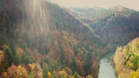 Aerial,-river-valley-with-autumn-tree-leaves-foliage-on-hills