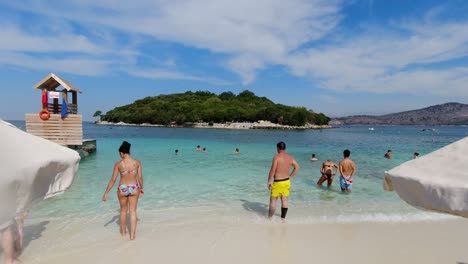 Crowds-gather-at-stunning-natural-Ksamil-Beach-in-Albania-on-clear-summer-day