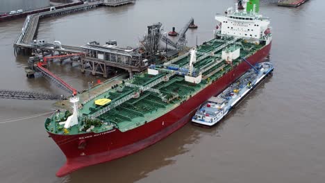 Silver-Rotterdam-oil-petrochemical-shipping-tanker-loading-at-Tranmere-terminal-Liverpool-aerial-zoom-in-closeup-view