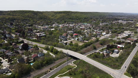 Aerial-view-showing-bridge-and-intersection-in-Grimsby-Village-during-sunny-day-in-front-of-green-hills,Canada