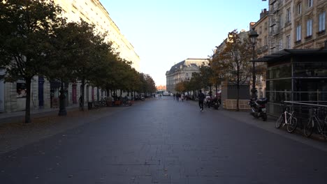 Chapeau-Rouge-promenade-with-people-walking-along-a-nearly-empty-street,-Walking-stable-shot