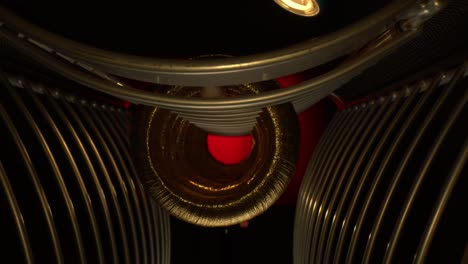 Starting-inside-a-series-of-threaded-golden-rings-that-are-back-lit-red-and-form-a-circle-in-the-center