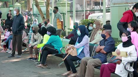 Diverse-people-lining-up-waiting-for-their-turn-to-get-shots-at-the-hospital-vaccination-center