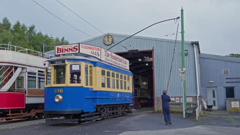 Man-changes-electrified-power-cables-for-vintage-passenger-tram