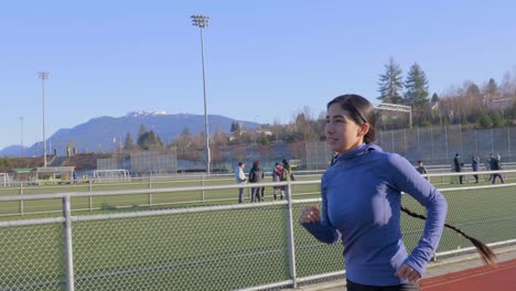 Fit-young-woman-jogging-tracking-gimbal-shot