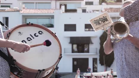 men-playing-musical-instruments-in-a-marching-band-in-Costa-Brava,-Cadaques,-Spain-on-May-24,-2022