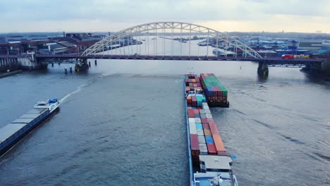 Aerial-Stern-View-Of-Circle-Inland-Container-Vessel-Approaching-Brug-over-de-Noord