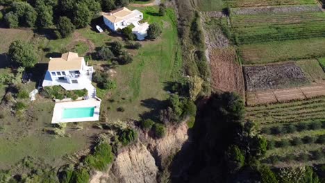 Smooth-aerial-drone-flight-slowly-sinking-down-drone-shot-of-two-ghost-houses-on-a-spooky-cliff