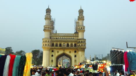 View-of-colorful-clothes-and-red-heart-balloons-on-sale-in-a-maket-in-front-of-Charminar-monument,-Hyderabad,-Telangana,-India