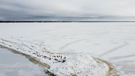 Aerial-drone-view-of-a-frozen-mole-in-the-middle-of-a-frozen-sea