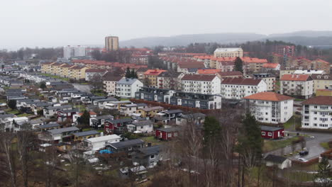 Living-district-of-private-and-apartment-buildings-in-Swedish-town-on-moody-day,-aerial-orbit-shot