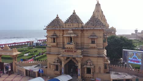 Aerial-rotating-shot-of-Somnath-mandir-with-people-entering-inside-the-mandir