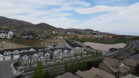 Home-and-townhouse-living-in-the-foothills-of-Travers-Mountain-in-Lehi,-Utah---aerial-sliding-view