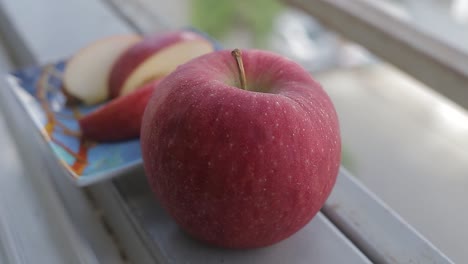 Fresh-red-apple-sliced-on-a-window