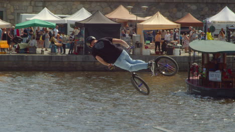 Prague-embankment-with-markets-and-a-BMX-rider-performing-a-trick-in-the-air
