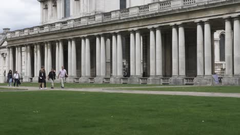 Tourists-Walking-Past-Along-Path-At-The-Old-Royal-Naval-College-In-Greenwich