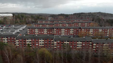 Flying-towards-countryside-residential-apartment-blocks-surrounded-by-Nature,-Sweden
