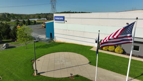Aerial-view-of-American-flag-waving-in-front-of-Volvo-building