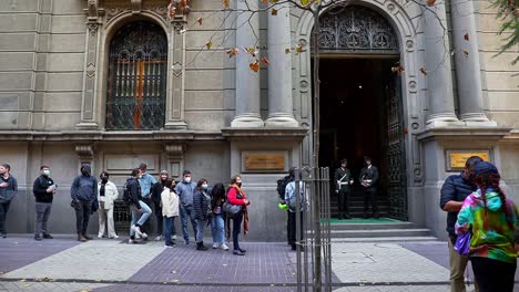 Handheld-tilt-up-of-people-gathered-outside-Chile's-constitutional-court-for-a-Heritage-Day-tour