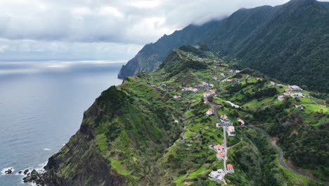 Village-situated-in-rugged-mountainous-landscape,-Porto-da-Cruz,-Madeira