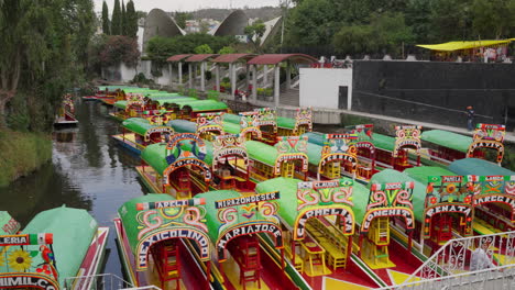 Rows-Of-Empty-Colourful-Gondolas-Parked-At-Boat-Station-At-Embarcadero-Nuevo-Nativitas