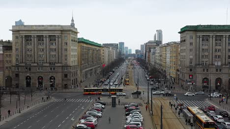 Aerial-drone-view-over-cars-and-buses-on-the-Marshal-Street-in-Warsaw,-cloudy-Poland