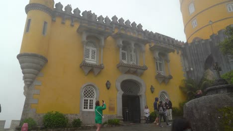 Yellow-Colour-Pena-Castle-Façade-With-Tourists-Taking-Photos-in-Front-of-It