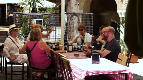 Group-Of-People-Sat-At-Restaurant-Cafe-Table-Outside-In-Nicosia