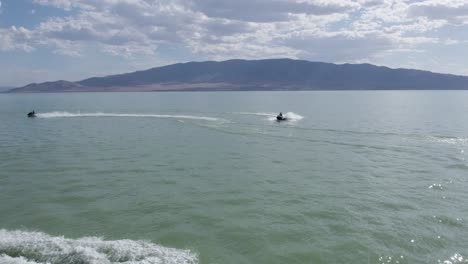 People-Enjoying-Summer-on-Utah-Lake-by-Riding-Jet-Ski-Sea-Doos-on-Water-Surface