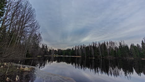 Timelapse-of-reflections-of-a-dramatic-sky-in-a-still-water-lake-in-winter