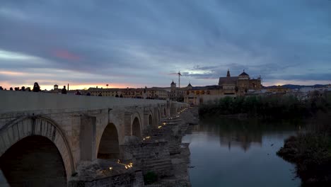 Beautiful-sunset-over-Roman-Bridge-and-Mezquita-in-Cordoba,-Spain