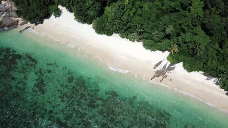 A-Drone-clip-from-above-at-an-empty-Tropical-Beach-called-Pasir-Panjang-on-Kapas-Island,-Malaysia-east-coast
