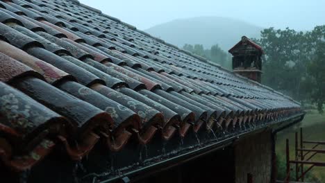 Typisches-Dach-Eines-Hauses-In-Der-Italienischen-Landschaft-Während-Eines-Schweren-Sturms,-Dachrinnen-Leiten-Regenwasser-Ab