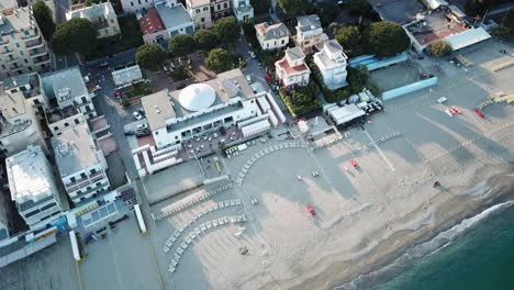 Top-view-of-an-italian-sandy-beach-with-an-hotel-and-buildings
