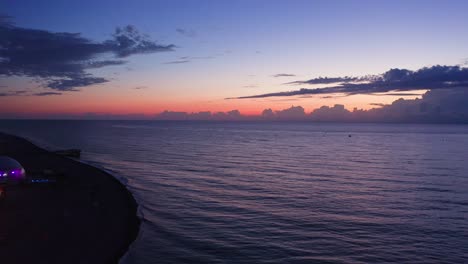 Drone-Flight-Above-Black-Sea-Expanse-Under-Beautiful-Evening-Sky-At-Dawn
