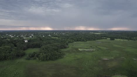 Ariel-view-of-green-forest-and-dramatic-sky-in-the-evening