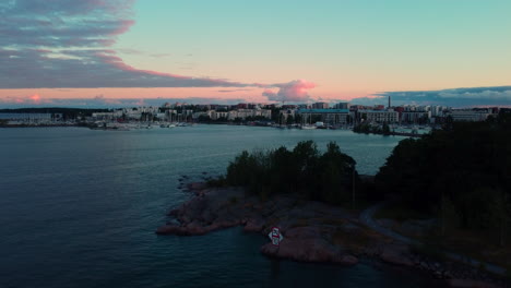 Aerial-view-revealing-the-marina-of-Lauttasaari,-summer-dusk-in-Helsinki,-Finland---rising,-drone-shot
