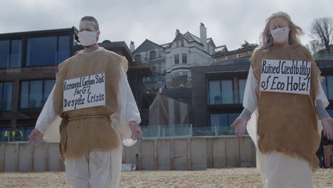 Activists-Message-Protest-for-Environmental-Damage-of-Trees-at-beach-in-front-of-Carbis-Bay-Hotel,-Cornwall