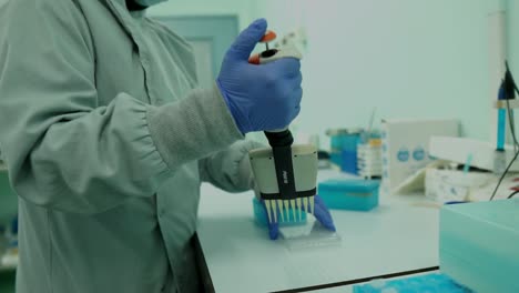 Female-Lab-Technician-Using-Multi-channel-Pipette-To-Fill-Multi-Well-Plate