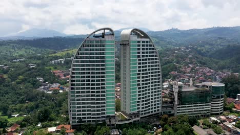 Maj-Meliá-Bandung-Dago-Spa-Hotel-resort-dual-buildings-on-overcast-day,-Aerial-orbit-left-shot