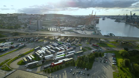 Cargo-Trailers-Trucks-Parked-near-Gdynia-Cargo-Container-Terminal-at-a-sunrise---aerial-view