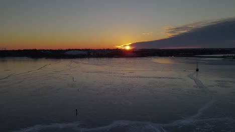 Luftaufnahme-über-Einem-Zugefrorenen-See-Bei-Sonnenaufgang