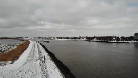 Verschneites-Flussufer-Des-Flusses-Noord-Unter-Bewölktem-Himmel-In-Den-Niederlanden-Im-Winter
