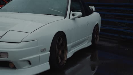 White-Nissan-180SX-Fastback-Sports-Car-From-1990s,-Autobody-and-Alloy-Wheels,-Slow-Motion