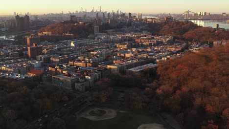 Clear-Golden-Hour-aerial-flight-over-Inwood-towards-The-Heights-and-Harlem-and-Midtown