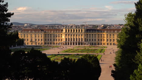 Slow-motion-view-of-Schönbrunn-Castle-and-people-walking-at-sunset