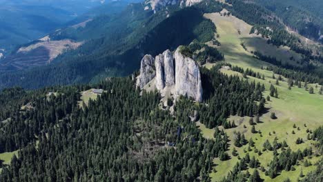 Bird's-Eye-View-Of-Unique-Rock-Formation-Of-The-Loney-Rock-With-Evergreen-Forest-At-Daytime-In-Romania